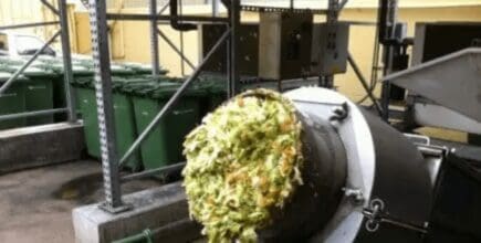 food being fed into an industrial grinder